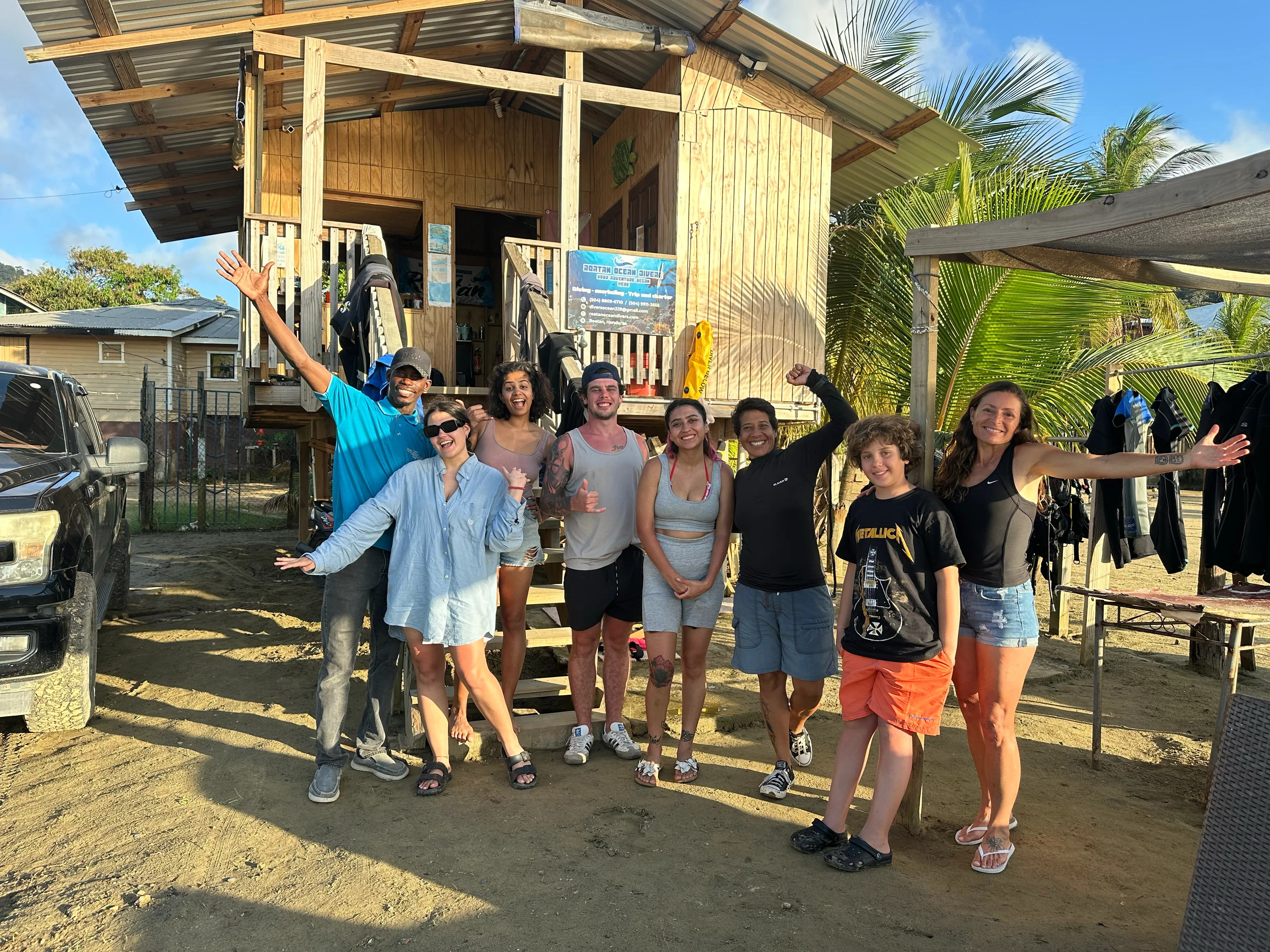 A group of friends and family celebrating outside the dive shop
